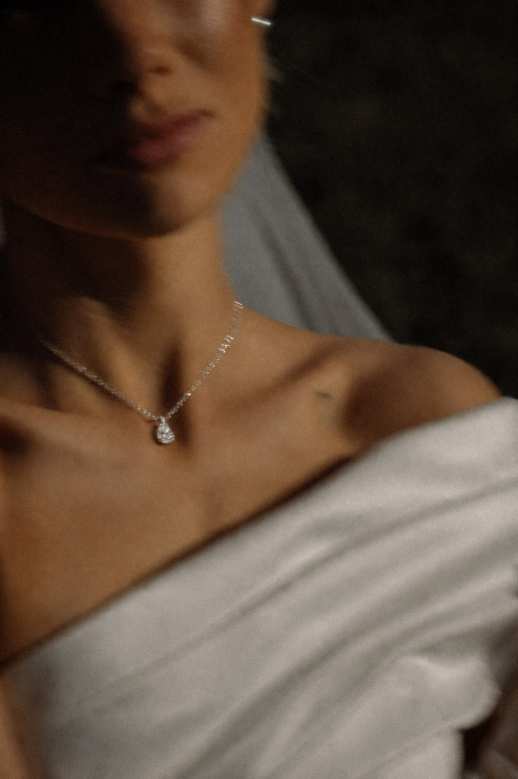 Fine jewellery against an ivory bridal neckline