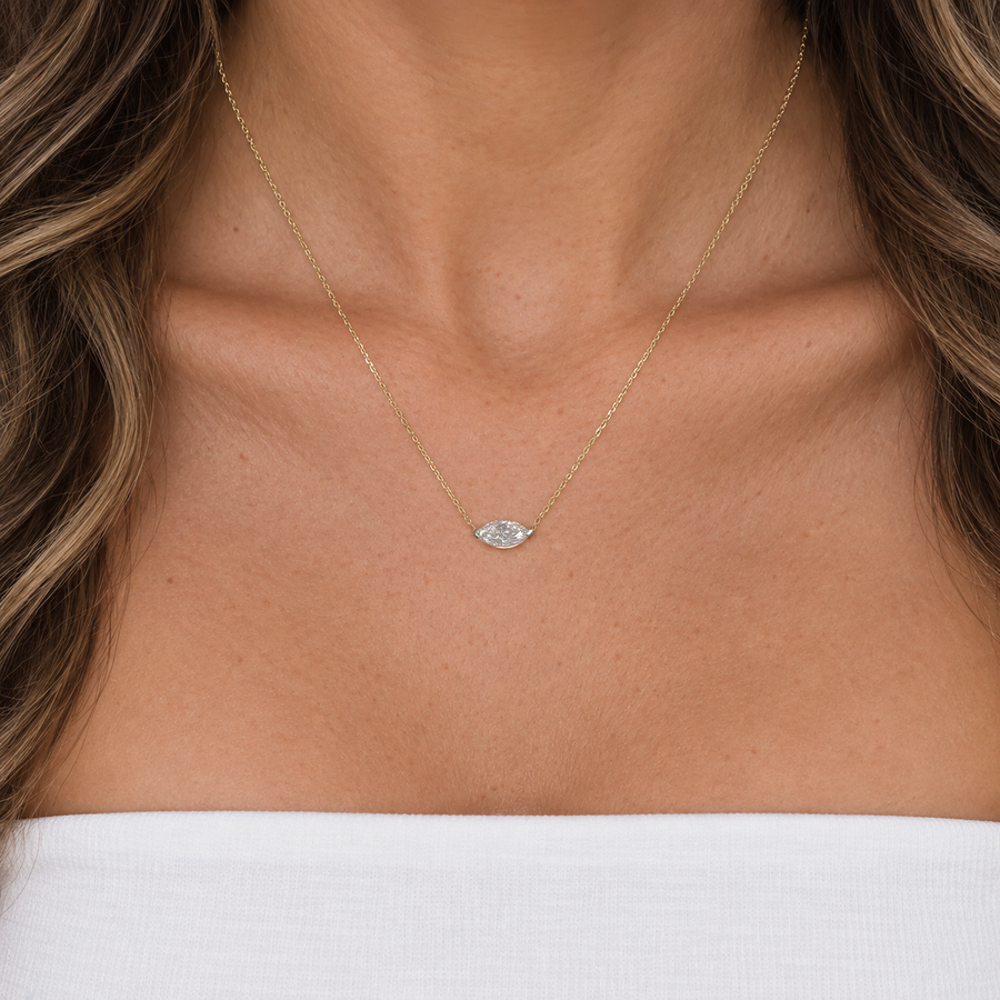 East-west marquise diamond necklace worn on a fine yellow gold chain