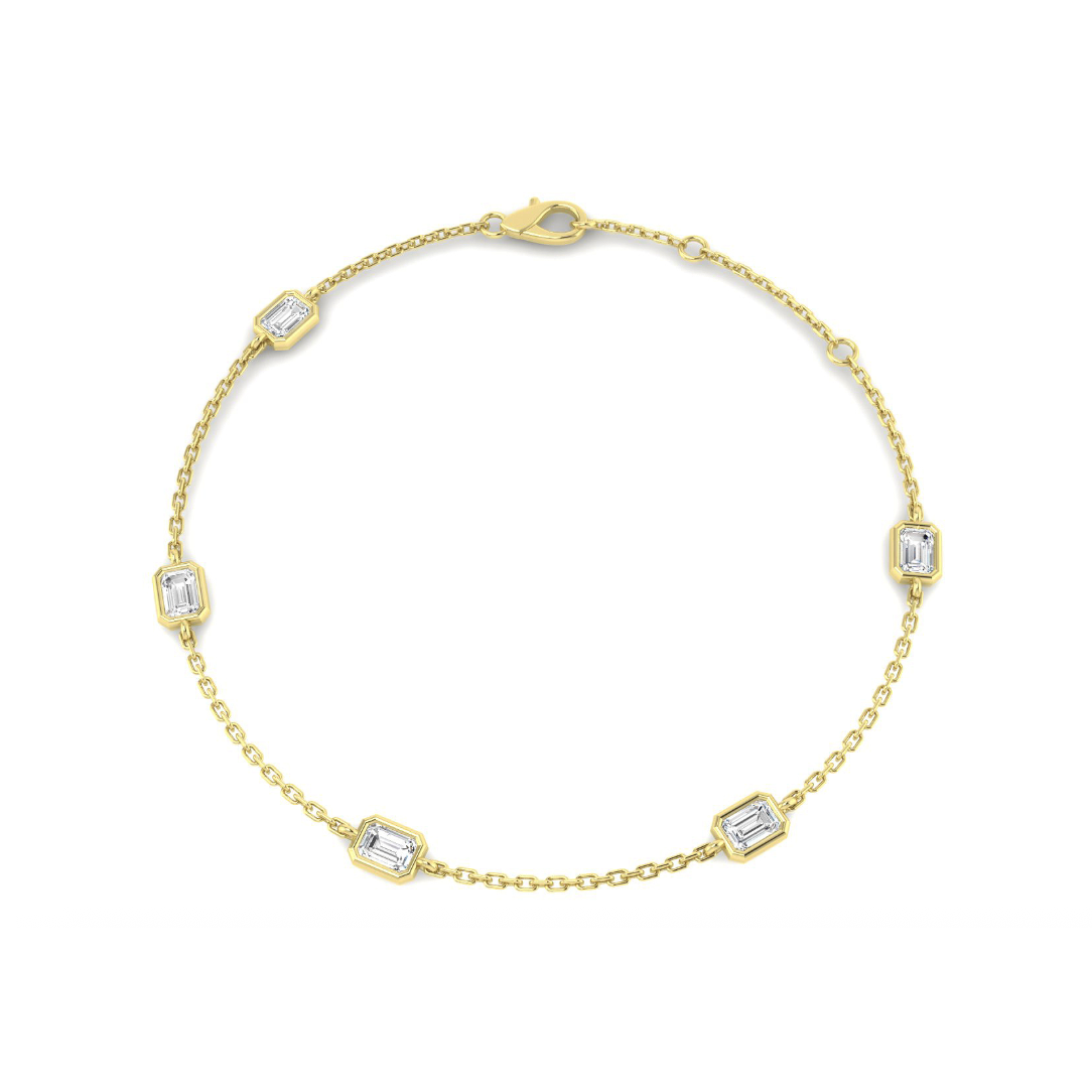 Five emerald-cut lab-grown diamonds in a 9K yellow gold station bracelet