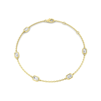 Five emerald-cut lab-grown diamonds in a 9K yellow gold station bracelet