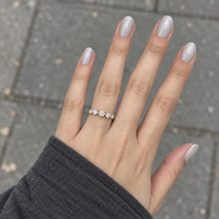 Graduated five stone diamond ring in yellow gold worn on a hand