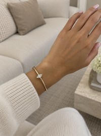 Marquise diamond bangle in yellow gold worn on a wrist