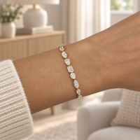 Mixed-cut bezel diamond bracelet in yellow gold worn on a wrist