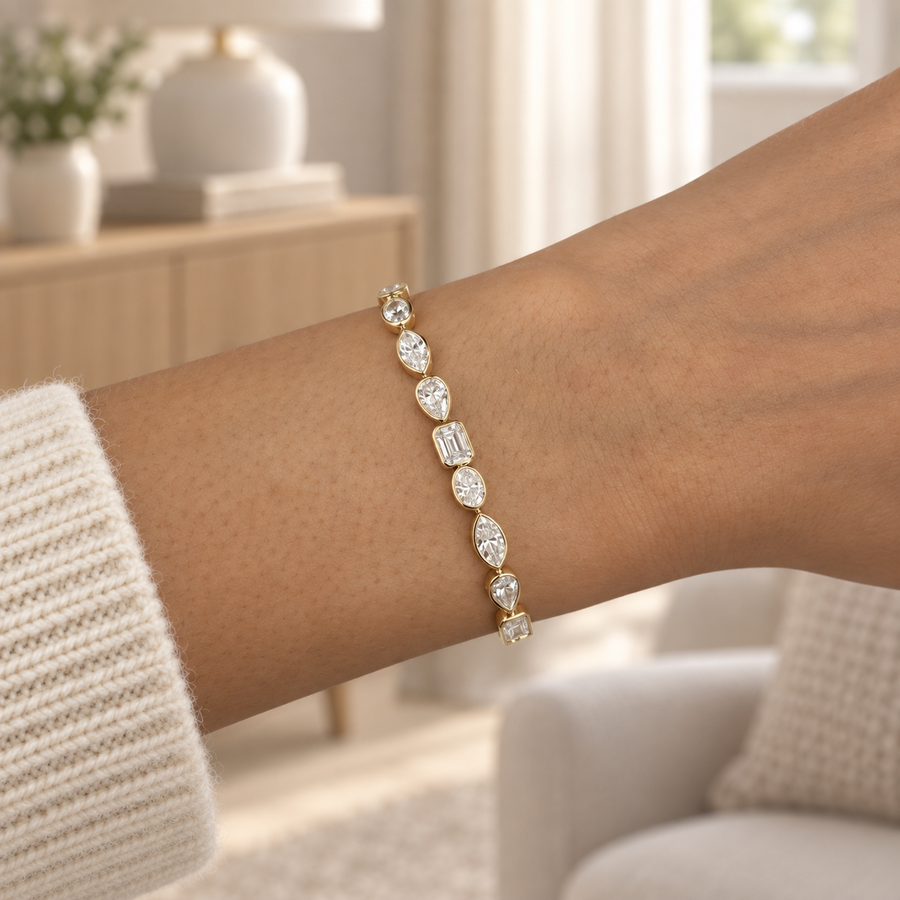 Mixed-cut bezel diamond bracelet in yellow gold worn on a wrist