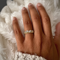 Twin pear natural diamond ring in yellow gold worn on a hand