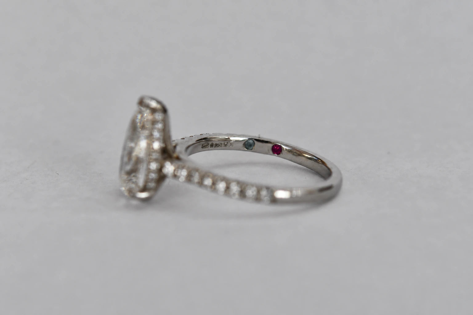 Original photograph of the ruby and blue topaz hidden inside the platinum band beside its hallmarks